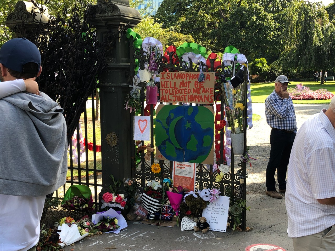 Signs and decorations adorn the gates to the Christchurch Botanical Gardens. One reads, "Islamophobia will not be tolerated. We are all just humans." These are signs and tributes to the victims of the Christchurch terrorists attacks.