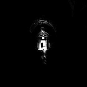 Person standing in a dark black and white lobby by Micrea Iancu from Pixabay