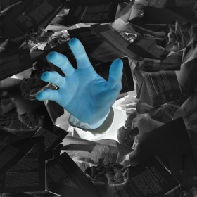 Inverse image of a hand reaching out from a sea of papers