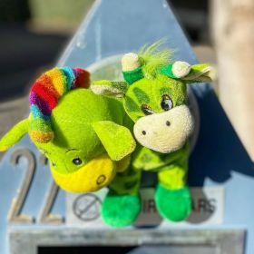 A green stuffed donkey with rainbow hair and a green stuffed giraffe toy stick out of a powder blue mailbox on 19 April 2020