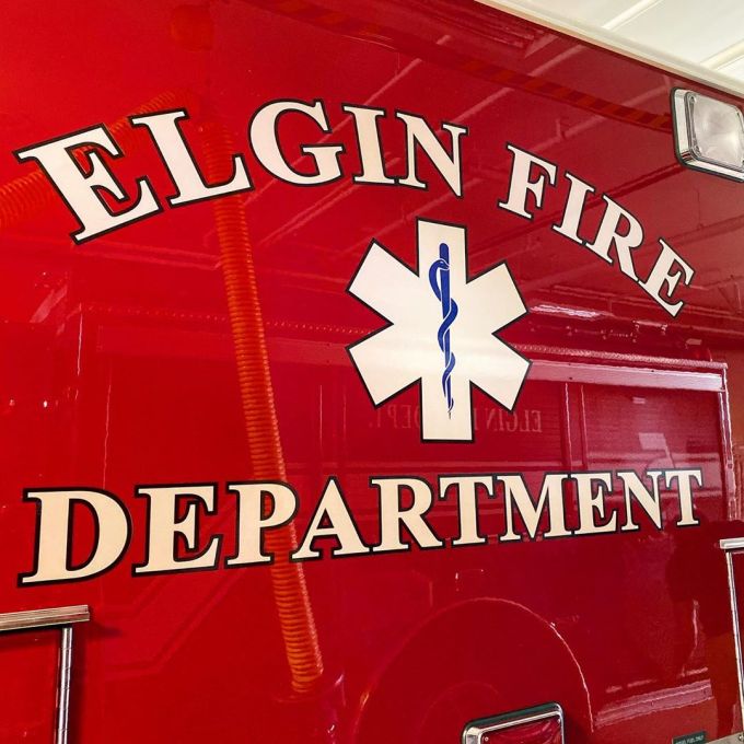 Paramedic emblem and the words "Elgin Fire Department" on a red ambulance
