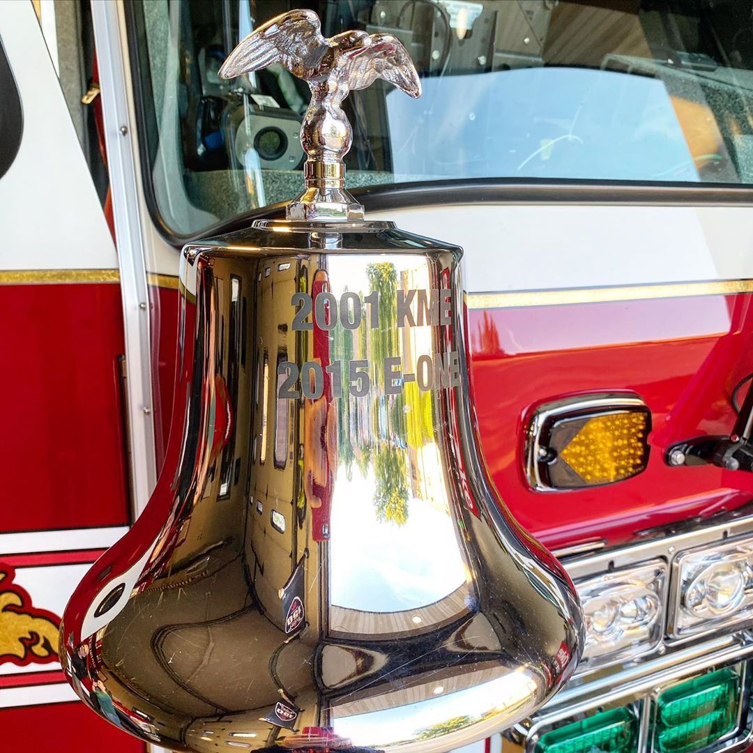 Bell with an eagle on the top attached to a fire truck