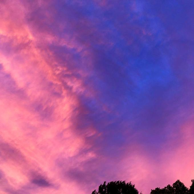 Dramatic blue, purple, salmon, coral, and pink clouds as the sunsets