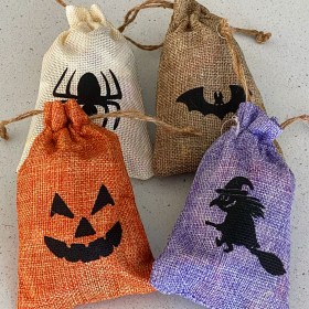 Four linen bags full of Halloween candy: Cream bag with a spider on it; Orange bag with a jack-o-lantern face on it; Brown bag with a bat on it; Purple bag with a witch on a broomstick on it