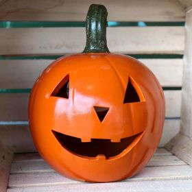 Decorative Halloween jack-o'-lantern on display in a wooden crate