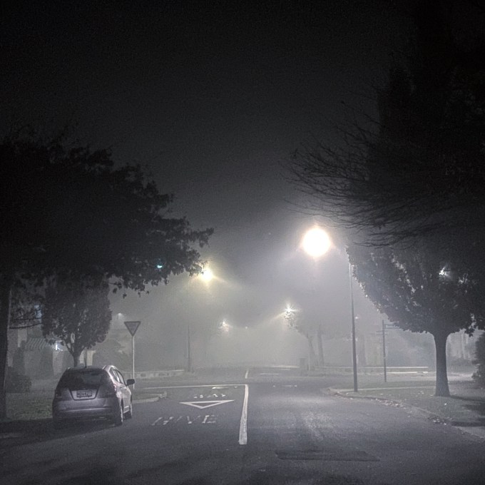 Fog creates halos around the street lights on a foggy street in Christchurch, New Zealand