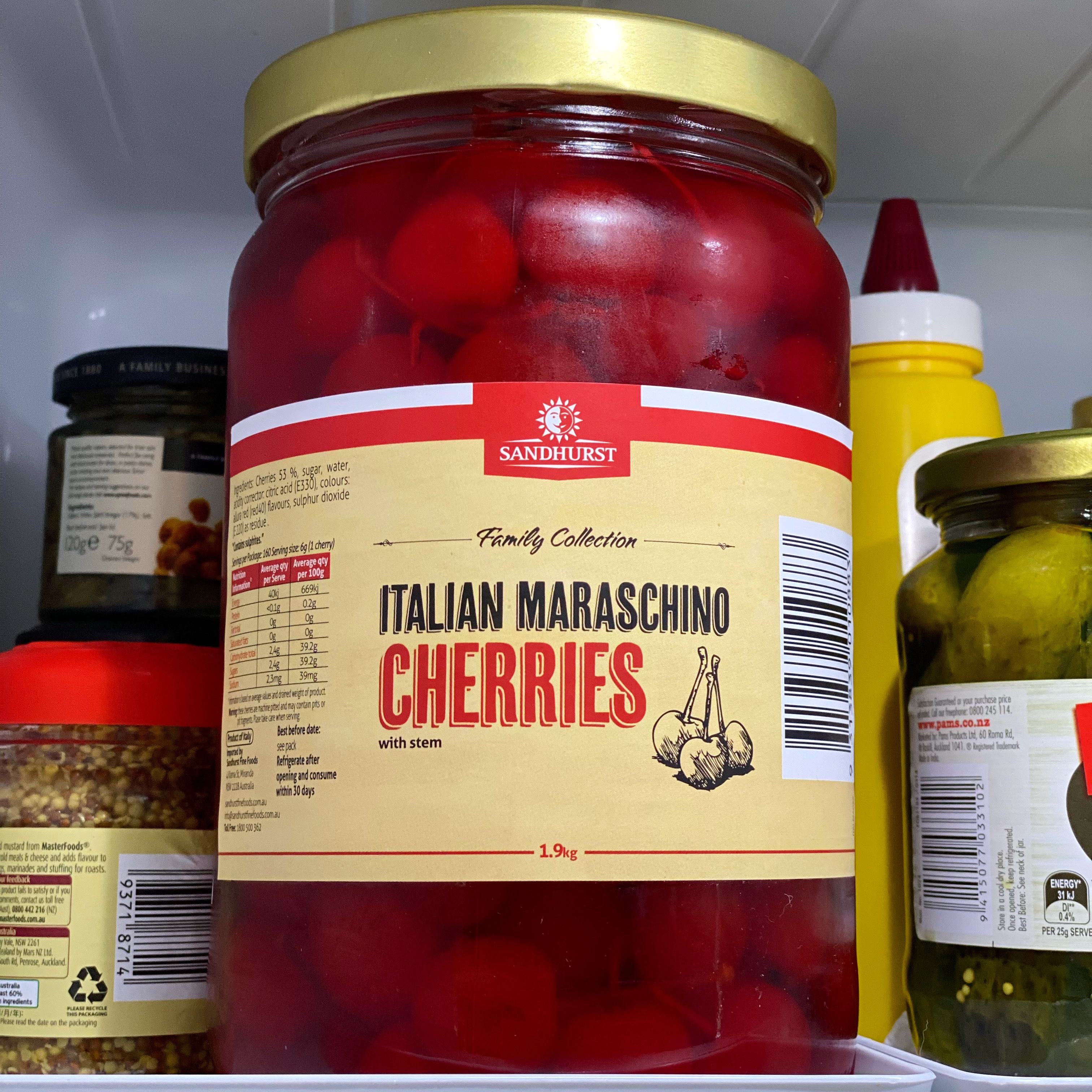 Jar of Sandhurst Family Collection Italian Maraschino Cherries, filled to the brim, in a clear red liquid