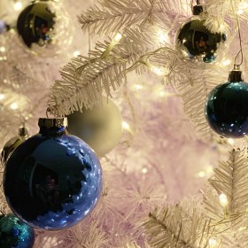 White Christmas tree with warm white LED lights and blue and silver ornaments